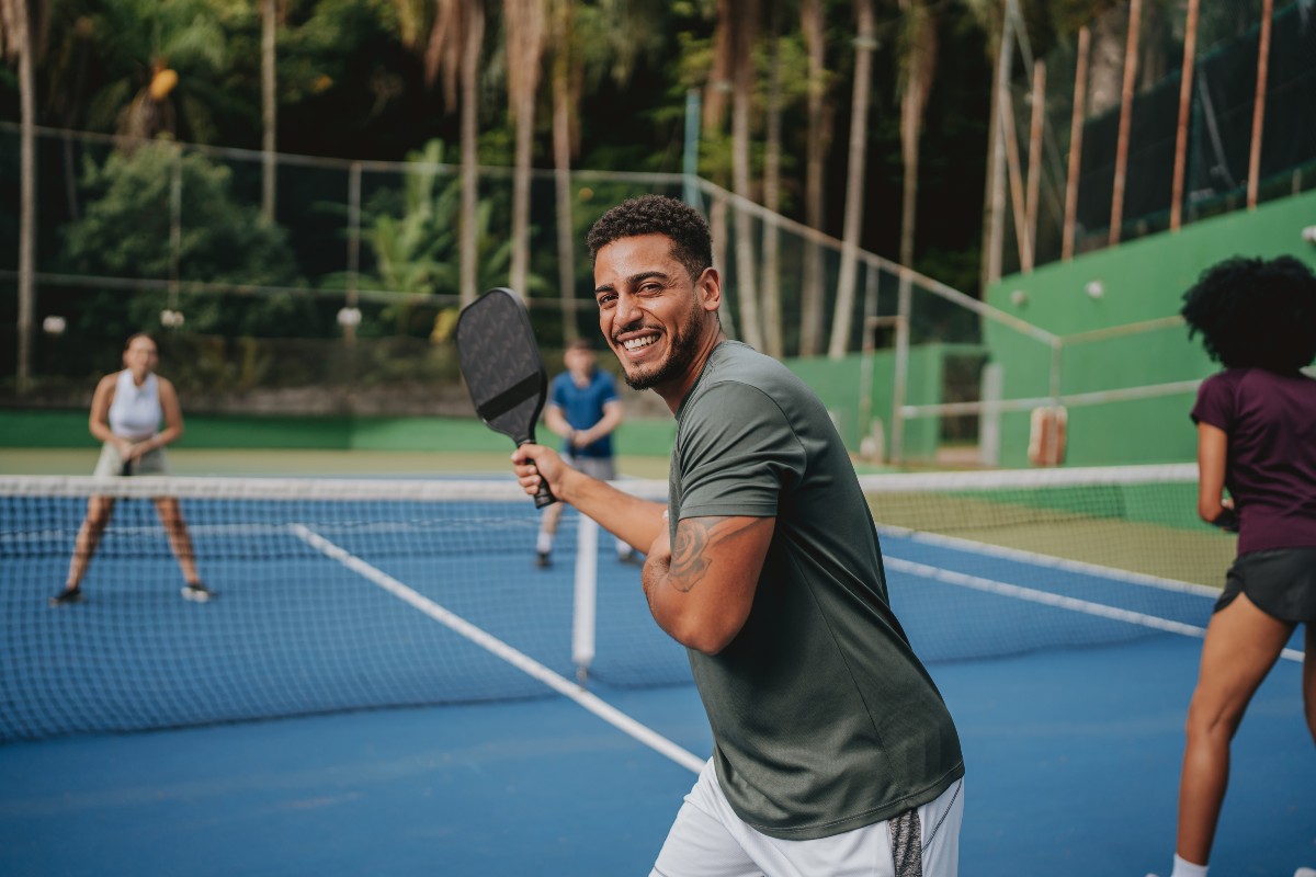 Guy playing pickleball