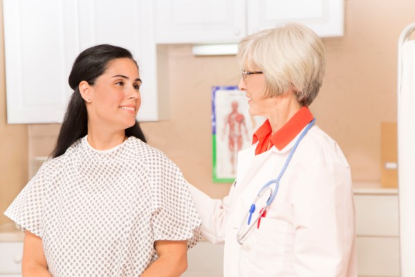 Woman prepares for exam at her doctor's office