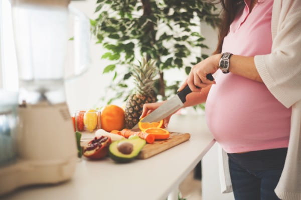 pregnant woman cooking healthy food