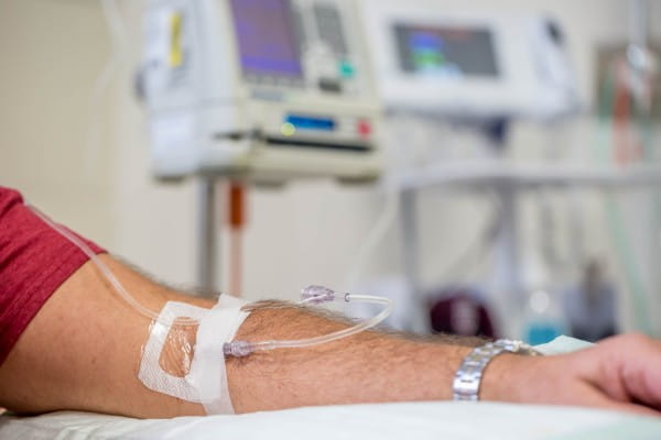 close up view of a mans arm while having an IV immunoglobulin infusion at hospital