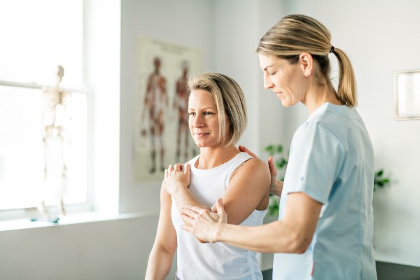 A Modern rehabilitation physiotherapy worker with woman client