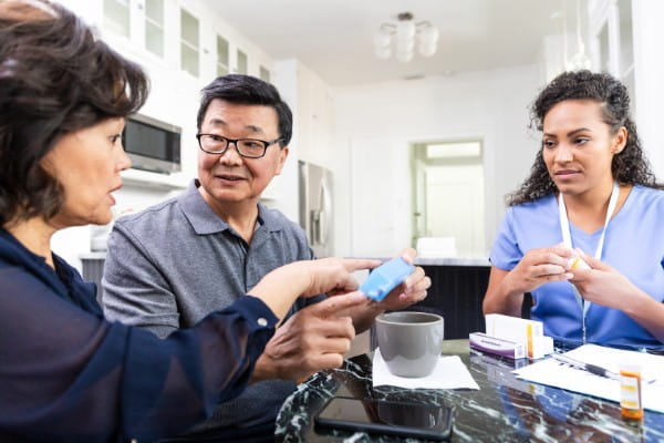 concerned couple asking a nurse about medication