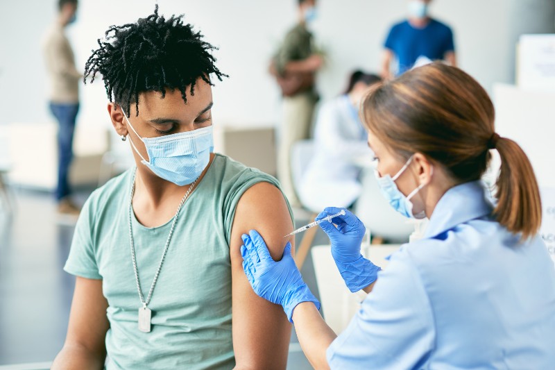 young adult male getting vaccine