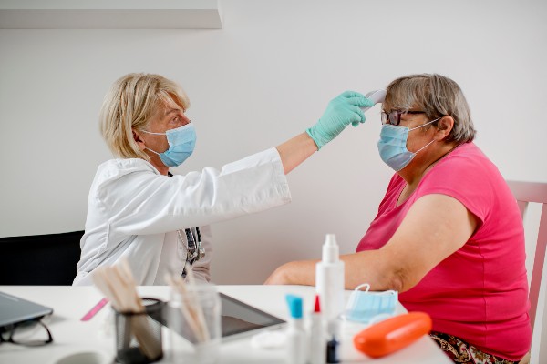 Doctor takes obese patient's temperature