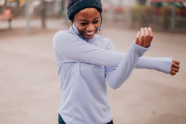 Photo of a young woman stretching out after her outdoors workout