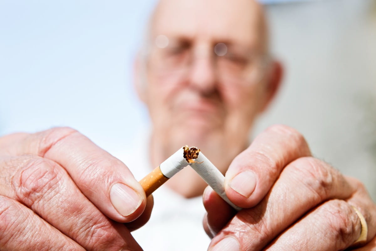 old man breaks cigarette 