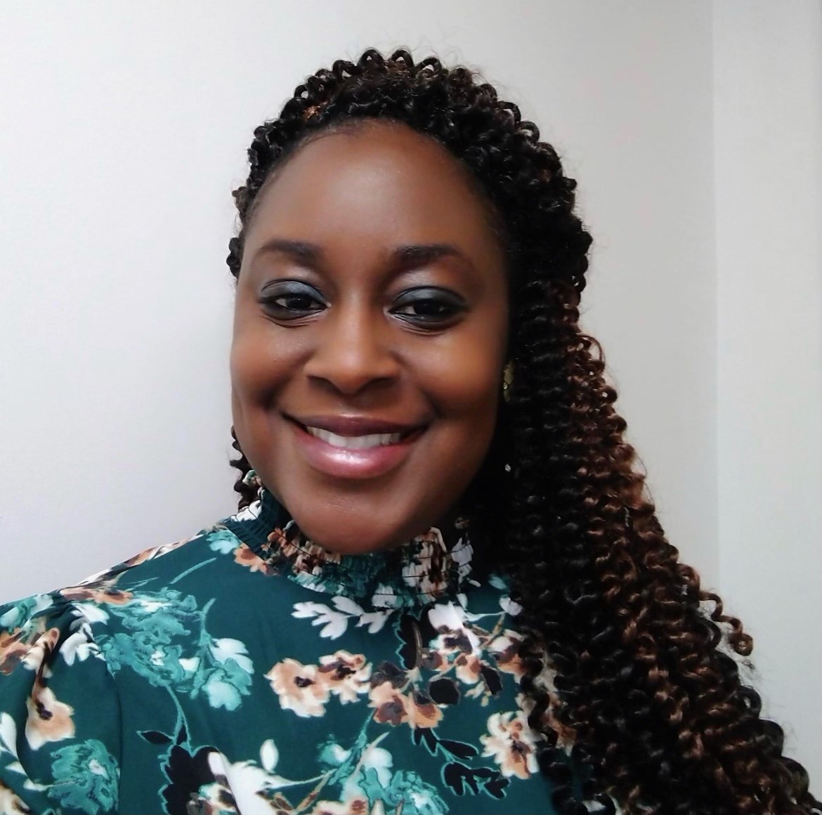 African American Woman in a floral shirt smiling