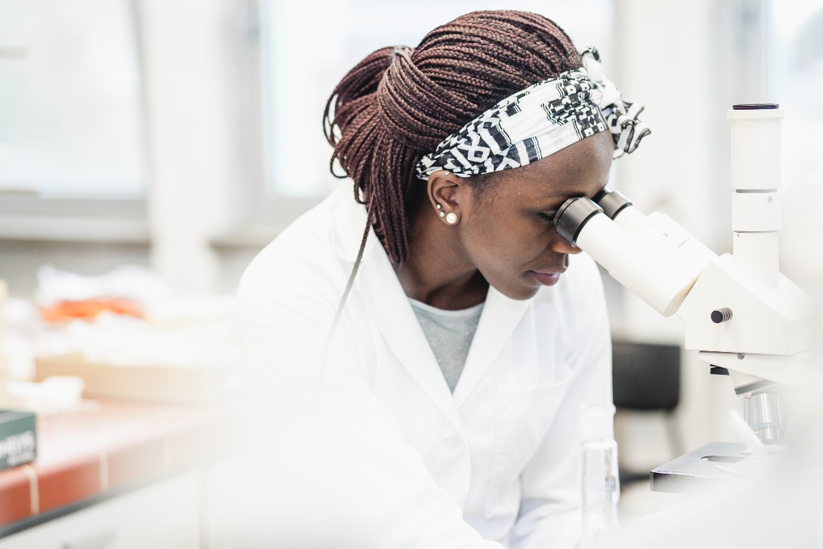 Scientist looking in microscope