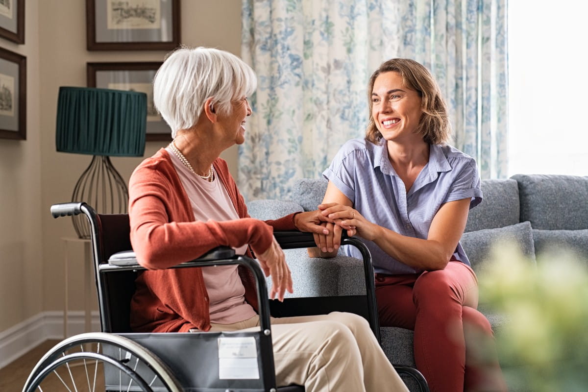 Happy adult woman visiting her elderly mother