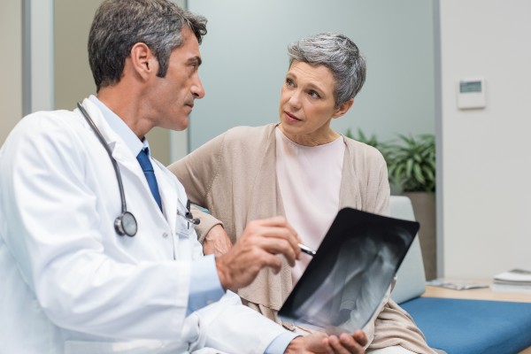 older woman looking at x-ray with her doctor