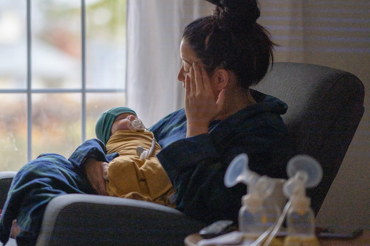 tired mom with newborn