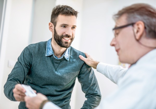 Happy mid adult man receiving a medicine from his doctor.