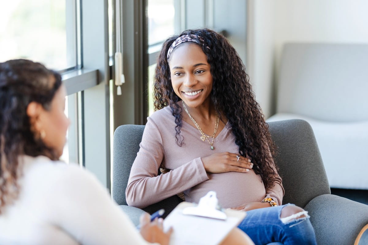 Young mom talking with doctor
