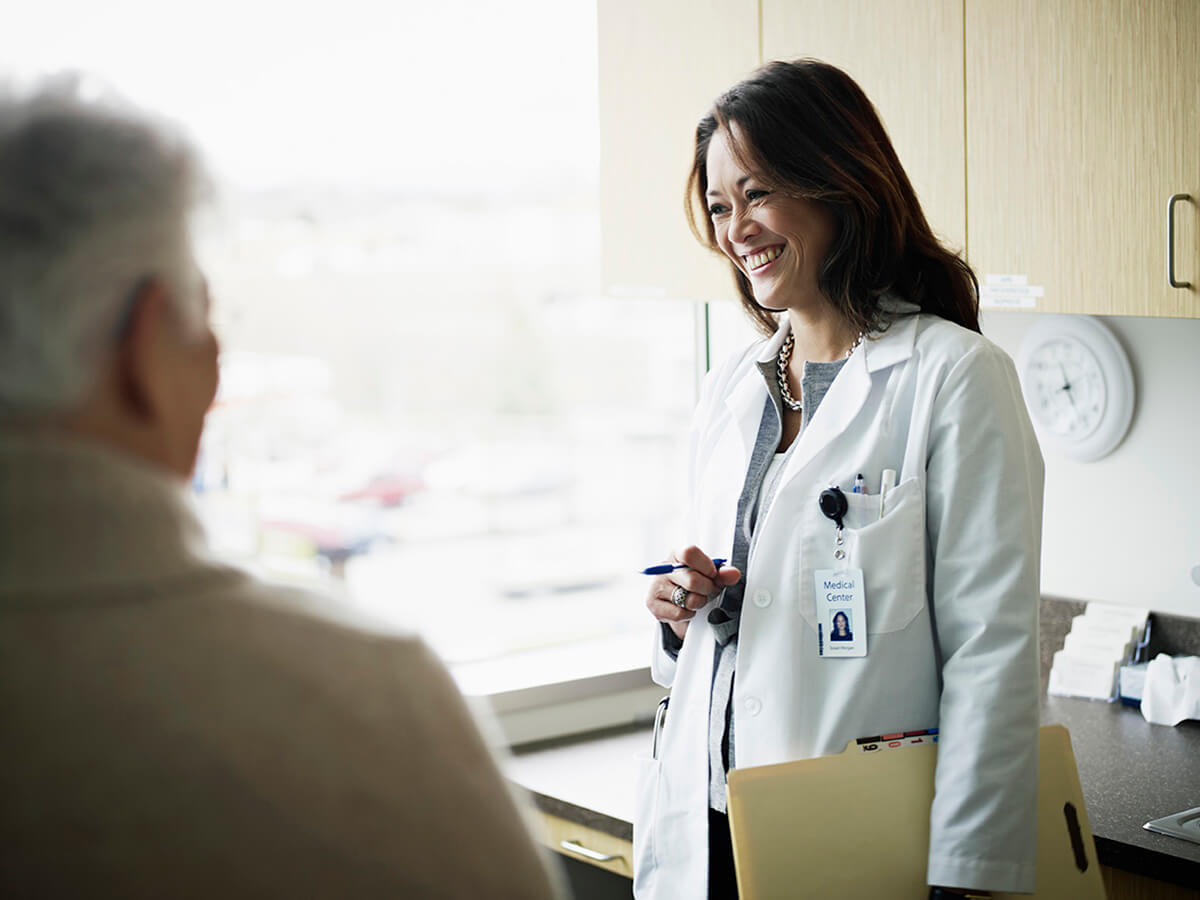 Doctor in discussion with mature female patient