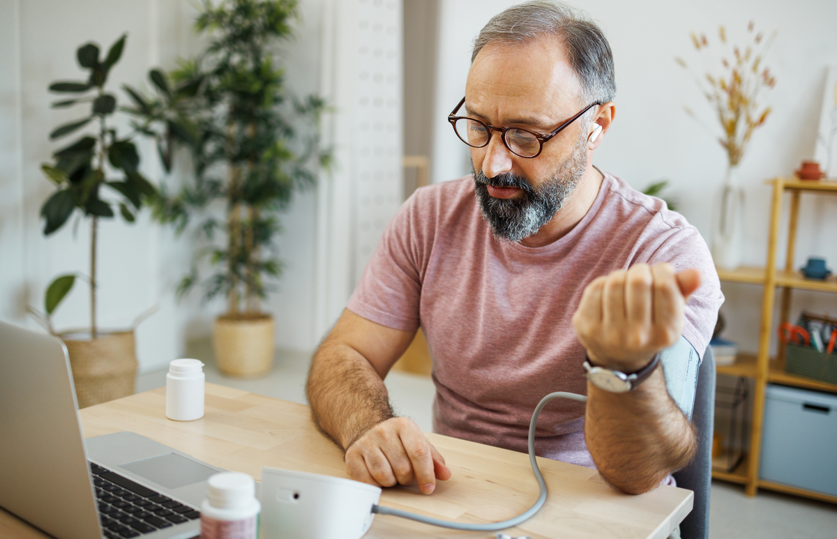 a white older man conducting a virtual primary care visit