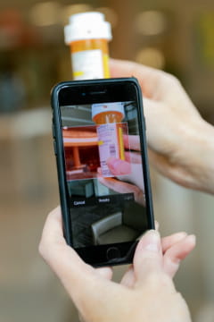 Woman scans prescription bottle using mobile app